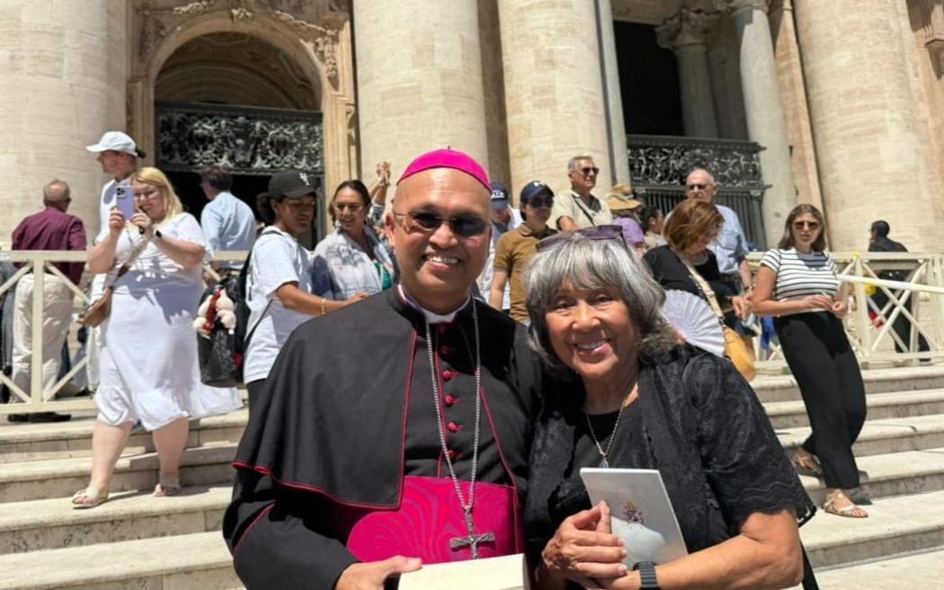 Archbishop Ryan P. Jimenez stands outside Saint Peter's Basilica in Rome with Guam pilgrim Louise Perez, a Mercy Associate with the Guam Sisters of Mercy.