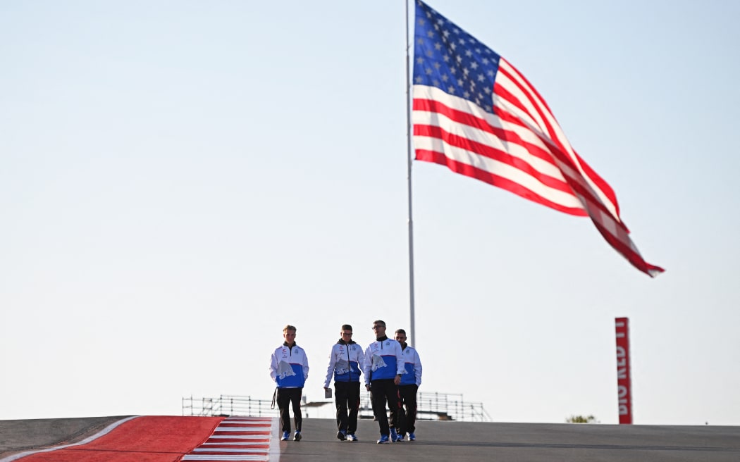 Liam Lawson of New Zealand and RB staff walk the track ahead of the 2024 F1 Grand Prix of United States at Circuit of The Americas in Austin, Texas.