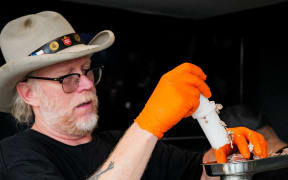 Bill Dumas tends to the meat grinder