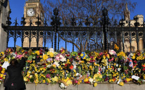 A well wisher lays flowers outside London's Houses of Parliament after the 22 March attack by Khalid Masood killed four and injured 29. Photo taken 25 March.