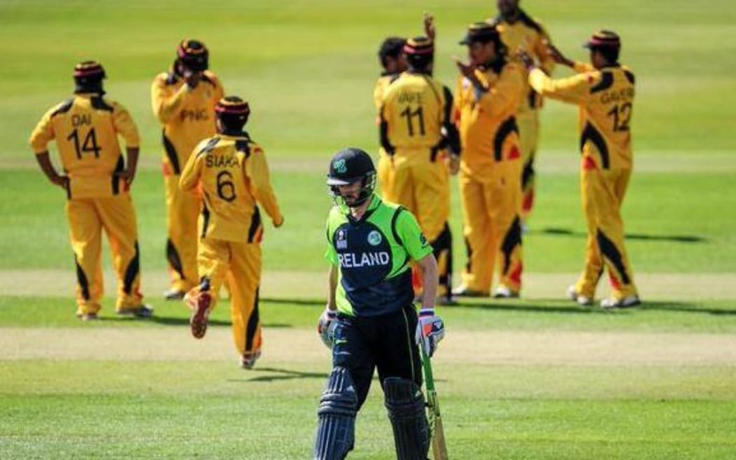 PNG players celebrate a wicket during their World T20 cricket qualifying win against Ireland.