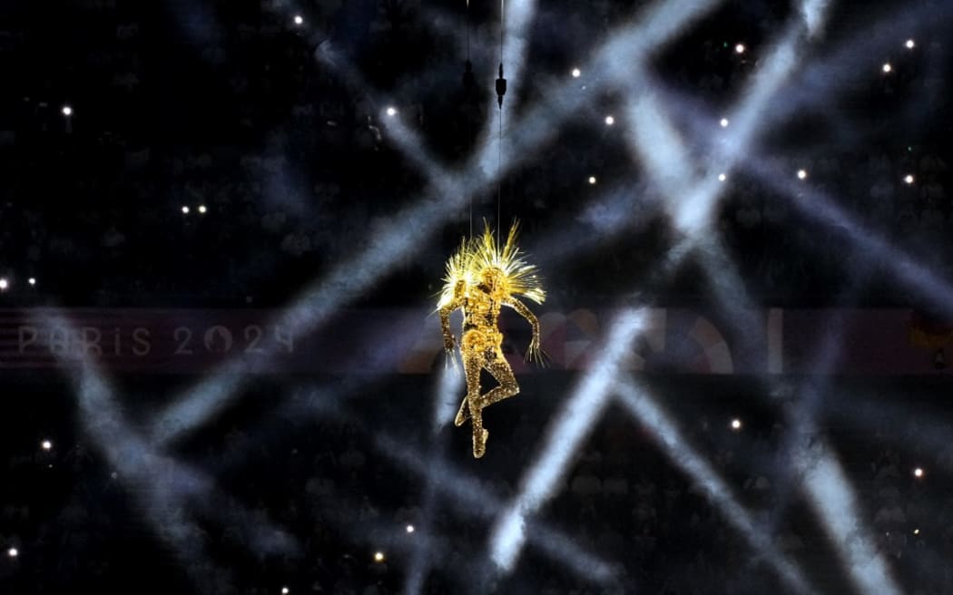 A statue of the Golden voyager descents from the sky during the closing ceremony of the Paris 2024 Olympic Games at the Stade de France, in Saint-Denis, in the outskirts of Paris, on August 11, 2024. (Photo by Dimitar DILKOFF / AFP)