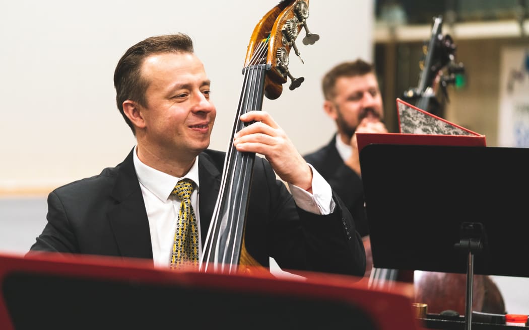 NZSO double bass Oleksandr Gunchenko playing his instrument.
