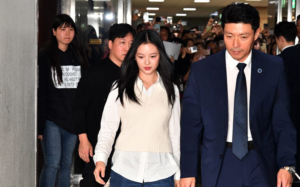 New Jeans' Hanni (centre) arrives to testify at the National Assembly in Seoul on October 15, 2024.
