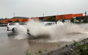 A car driving through floodwaters in Whangārei on 9 May 2023.