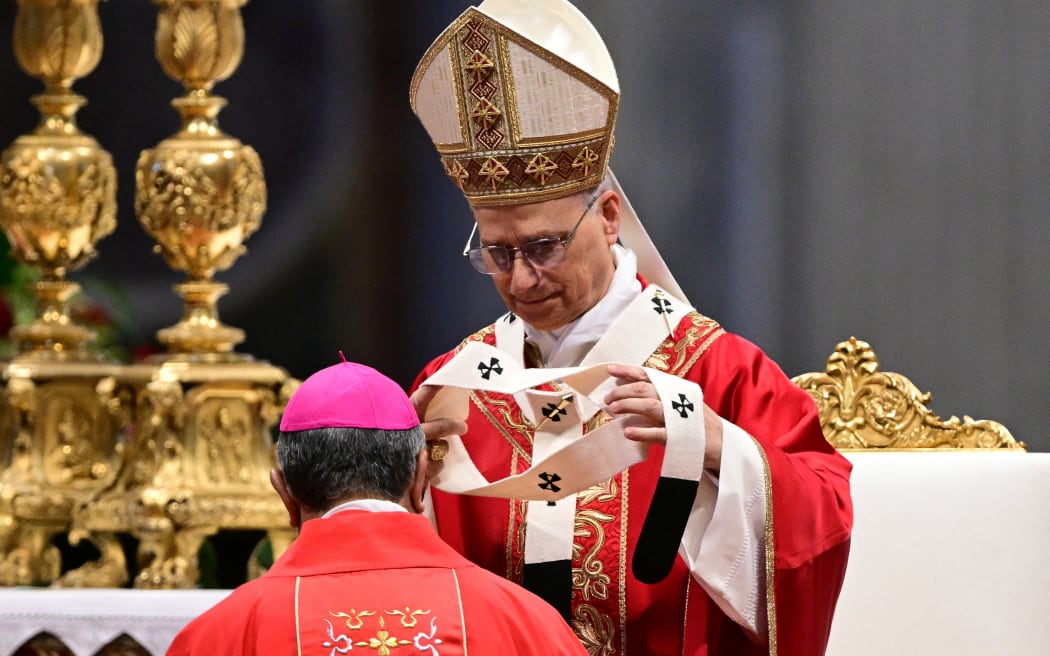 A new archbishop receives the pallium from Pope Leo XIV during a mass on the day of Saints Peter and Paul feast at St Peter's basilica in The Vatican, on June 29, 2025. (Photo by Tiziana FABI / AFP)