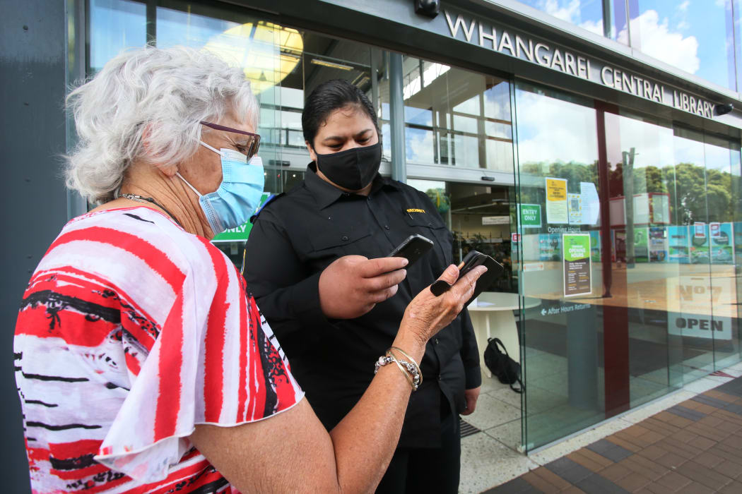 Northern Districts security guard Durhy Turner scans Margaret Johnson into WDC's Whangārei central library.
