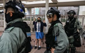 A school student is questioned by police in the Sai Wan Ho district in Hong Kong on November 12, 2019 following a day of pro-democracy protests.