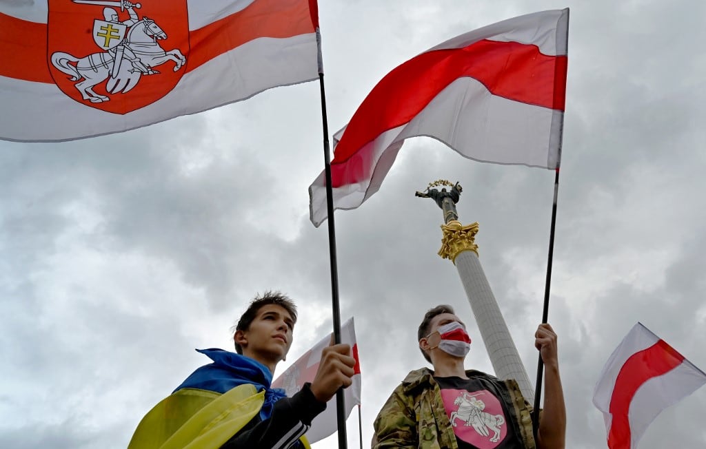 Members of the Belarus diaspora wave national flags during a "Free Belarus" rally at Independence Square in Kiev on August 1, 2020, a week before the Belarus presidential election.