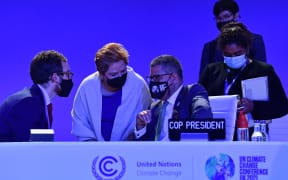 Britain's President for COP26 Alok Sharma speaks with UNFCCC Executive Secretary Patricia Espinosa and other members of his team following an informal stocktaking session at the COP26 Climate Change Conference in Glasgow on 12 November 2021.