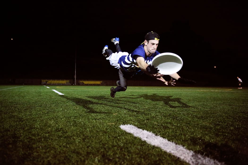 Matt Dol in full flight playing ultimate frisbee.
