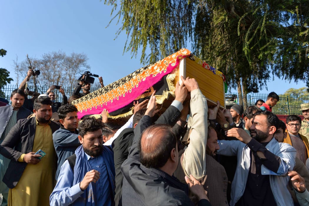Mourners carry the coffin of Malalai Maiwand, who was shot dead by gunmen in Jalalabad.