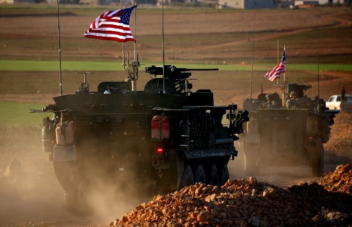 A convoy of US forces armoured vehicles on the western outskirts of the northern Syrian city of Manbij in March.