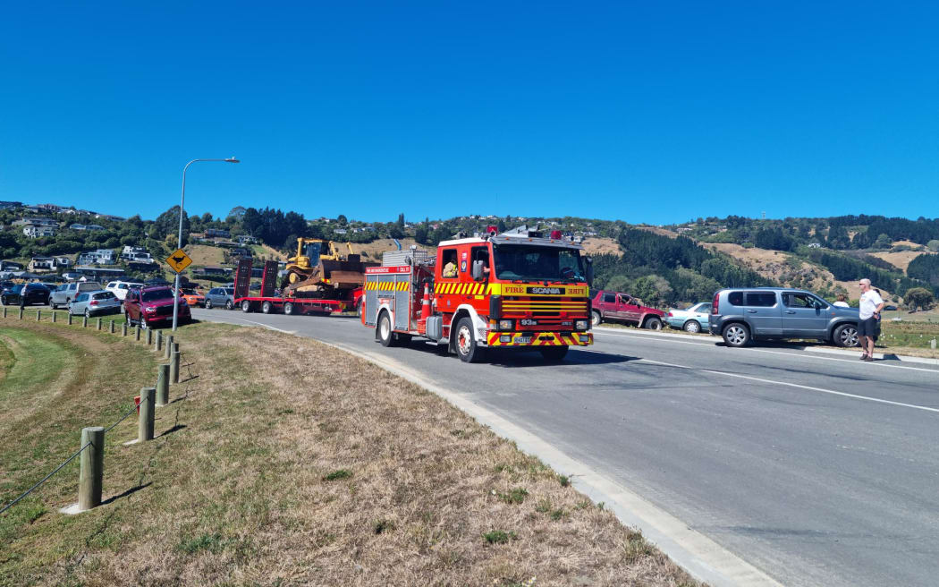 Heavy machinery and trucks heading to the Port Hills fire in Christchurch on 14 February, 2024.
