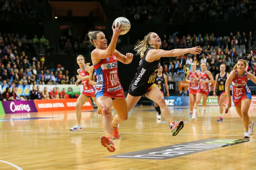 NSW Swift's Kimberlee Green takes a pass under pressure from Waikato BOP's Jamie-Lee Price during the ANZ Netball Championship semi final.