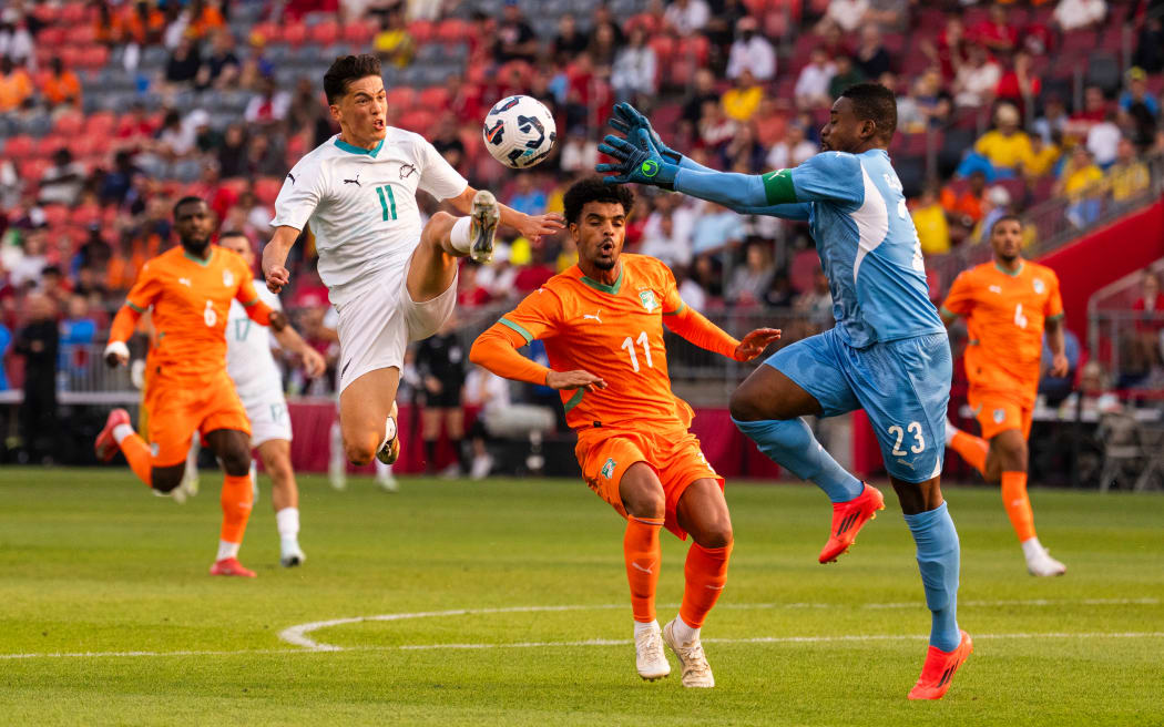 Elijah Just contests possession for the All Whites against Ivory Coast.