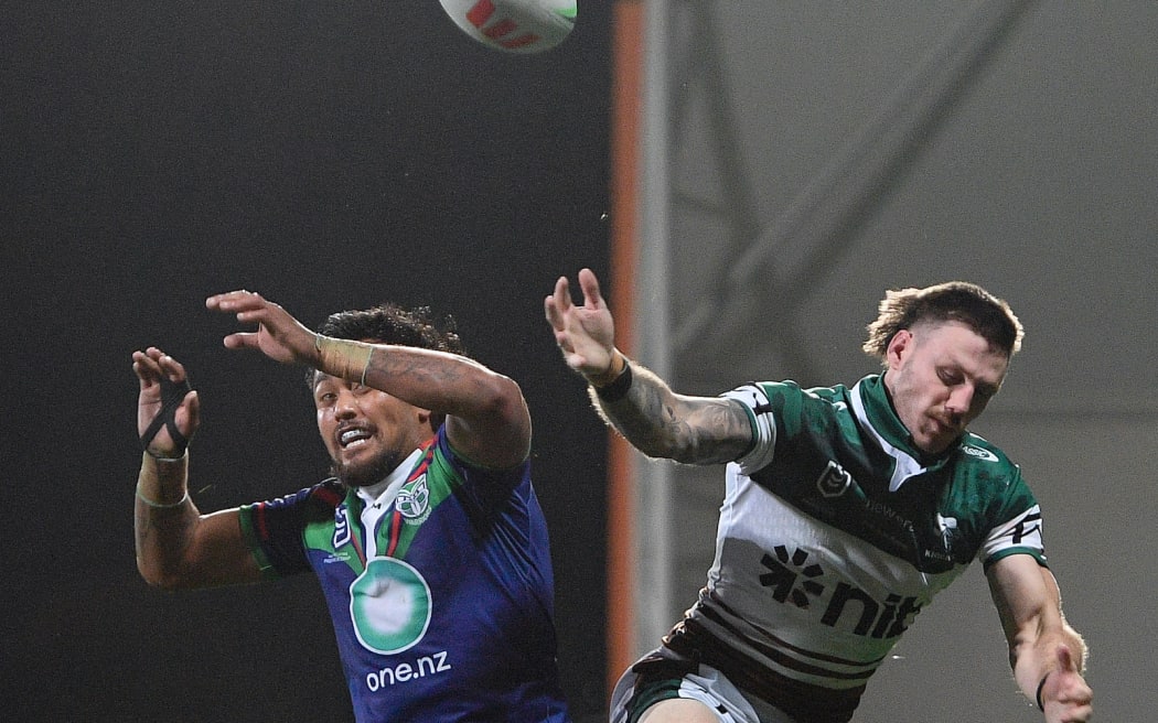 James Schiller of the Knights and Adam Pompey of the Warriors go for a hight ball during the NRL Telstra Premiership, Warriors Vs Knights.