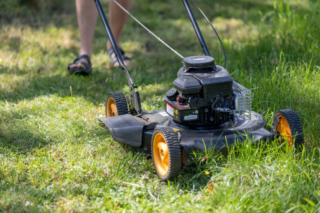 A man mowing a lawn.