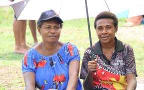 Two women attending the ceremony to mark the start of Patiko-Nuangawai access road’s rehabilitation work