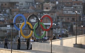Olympic rings overlook a favela outside the Maracana stadium in Rio.