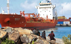 The fuel ship Media stretched almost the entire width of the Avatiu harbour as groups of holidaying youngsters watched on. This picture was taken in 2022. 22122209.
