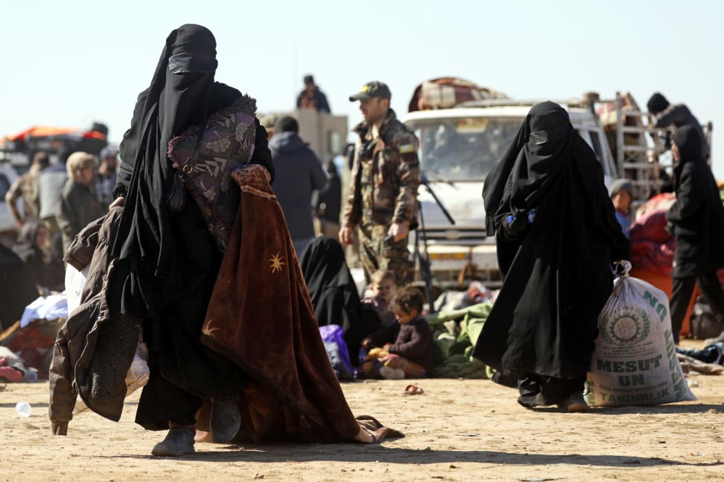 Civilians flee fighting between Syrian Democratic Forces (SDF) and Islamic State (IS) jihadists in the frontline Syrian village of Baghuz.
