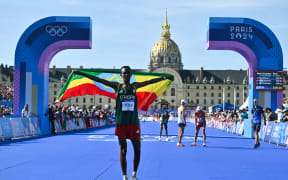 Ethiopia's Tamirat Tola celebrates winning the men's marathon at the Paris Olympics.