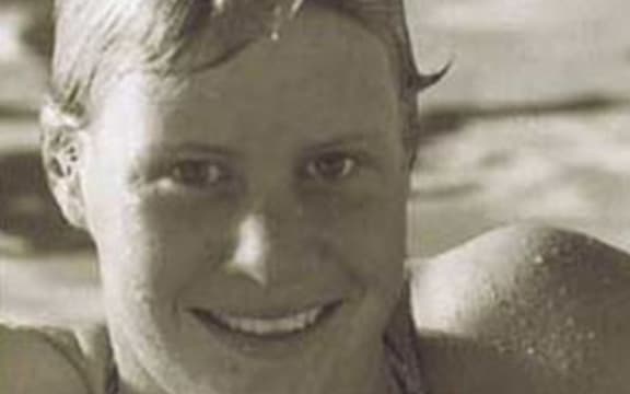 A prtrait of swimmer Rebecca Perrott leaning on the edge of a pool.