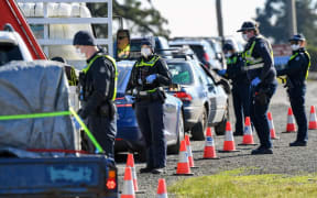 Police conduct roadside checks on the outskirts of Melbourne on July  9, 2020 on the first day of the city's new lockdown.