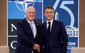 French President Emmanuel Macron (right) shakes hands with New Zealand Prime Minister Christopher Luxon prior to a meeting on the sidelines of the NATO 75th anniversary summit at the Walter E. Washington Convention Center in Washington, DC, on 10 July, 2024.