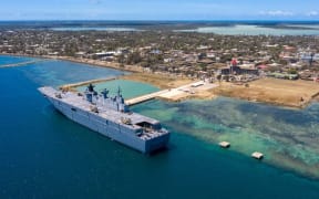 the Australian Defence Force shows the HMAS Adelaide sitting alongside Nuku'alofa to deliver and medical supplies following the eruption of undersea volcano Hunga Tonga-Hunga Haapai on 15 January and tsunami.