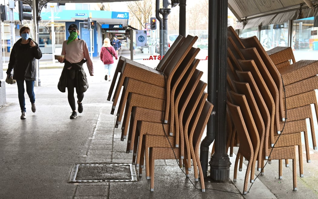 Chairs are stacked up outside a closed restaurant in Melbourne's Lygon Street on August 12, 2020, during a strict stage four lockdown