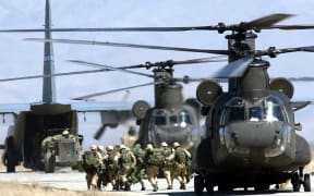 US soldiers disembark from a helicopter at Bagram Air Base on March 12, 2002.
