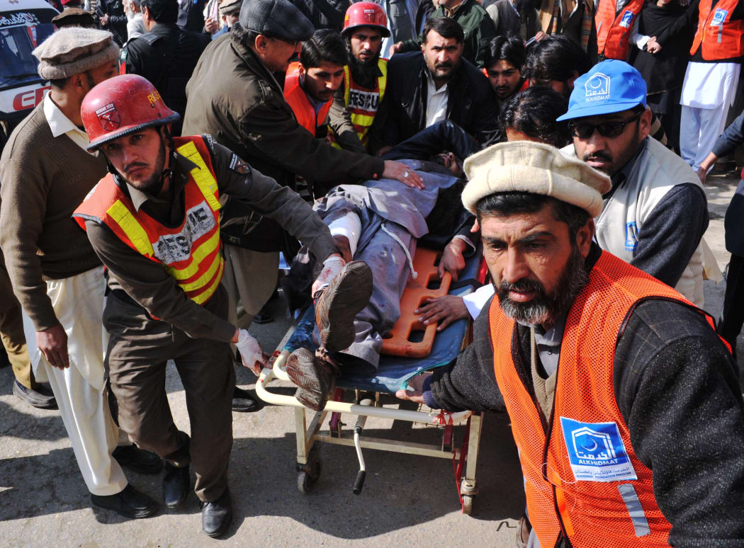 Pakistani rescuers shift an injured man to a hospital following an attack by gunmen in the Bacha Khan university in Charsadda, about 50 kilometres from Peshawar, on January 20, 2016.