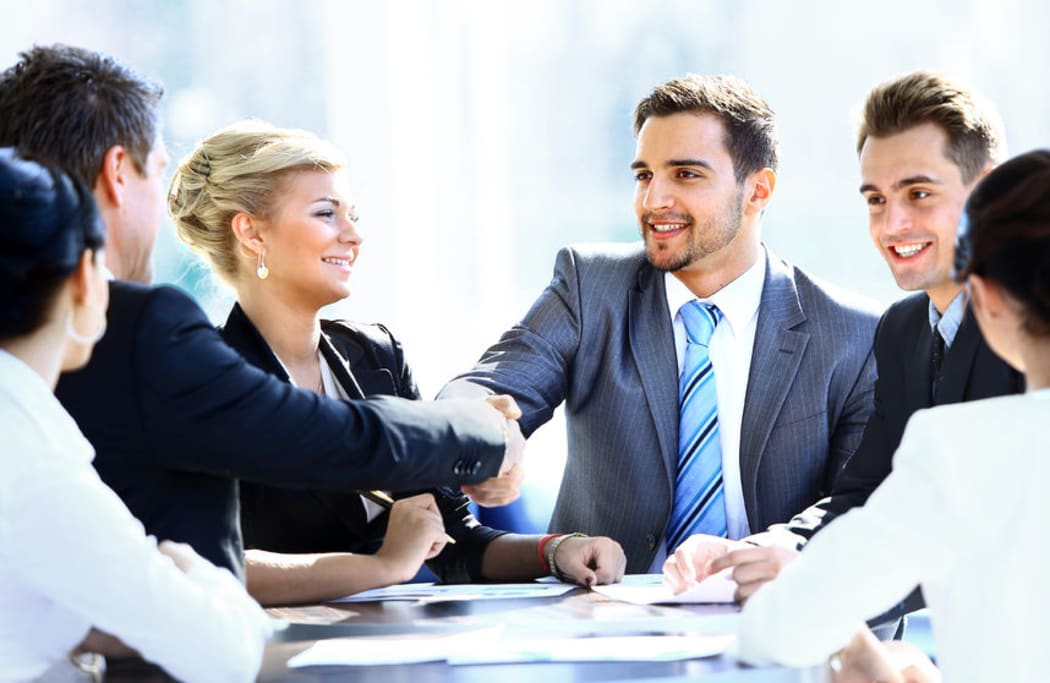 Men and women at an office meeting