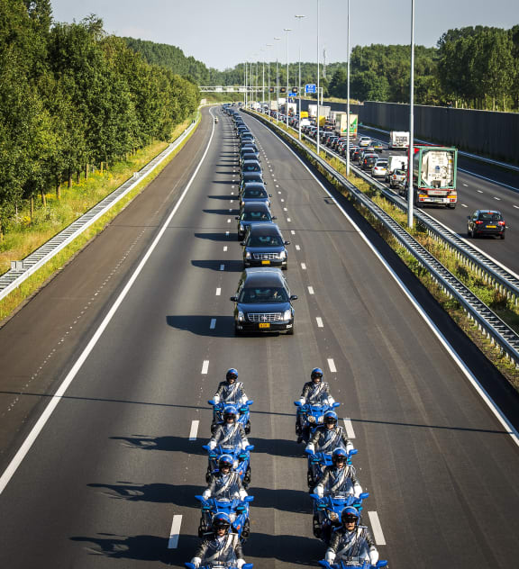 A convoy of hearses carrying coffins makes its way from Eindhoven Airbase to Hilversum.