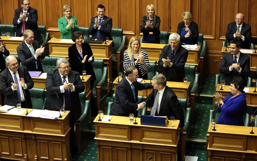 MPs clap in the house after Bill English finishes delivering his Budget.