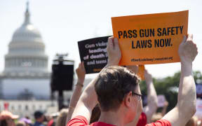 People attend a rally near the US Capitol on 8 June 2022, calling for Congressional action on gun safety in the wake of continued mass shootings.