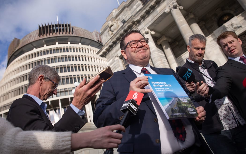 Finance minister Grant Robertson showing the cover of Budget 2023 the day before its reveal