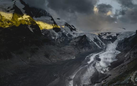 steep brown hill with rocks and blue sky