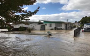 Floodwaters course through the streets of Edgecumbe