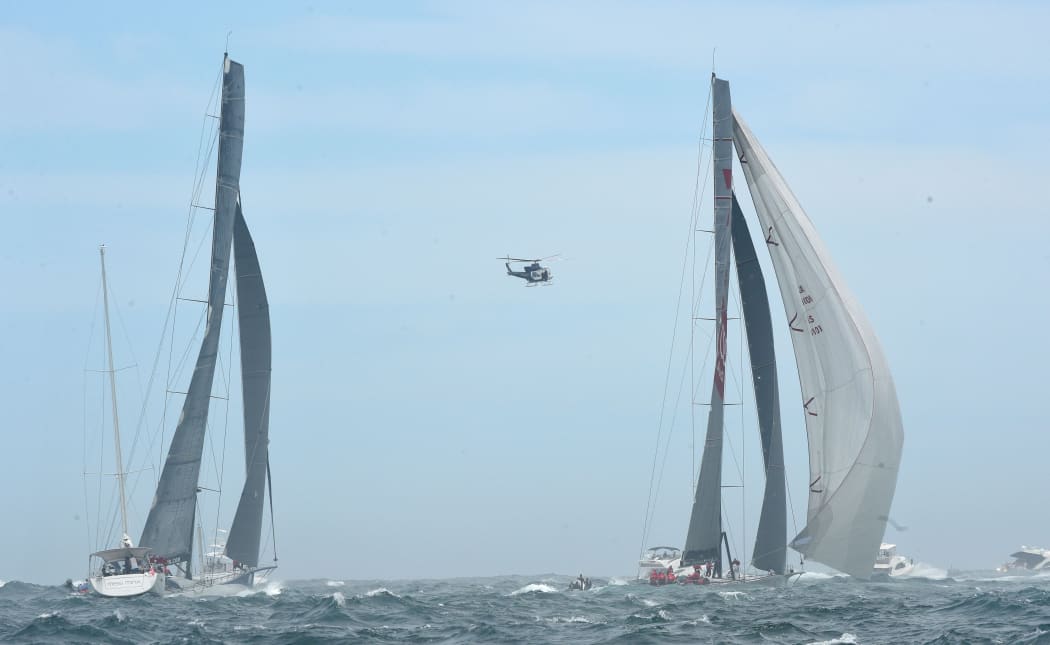 Yachts Wild Oats XI (R) and Ragamuffin 100 at the start of the 71st Rolex Sydney to Hobart yacht race on Sydney Harbour in Sydney on Saturday, Dec. 26, 2015.