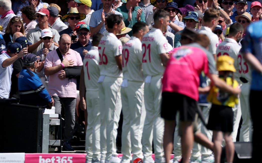 Ahmed Al Ahmed, the man who tackled and disarmed one of the Bondi beach attackers, walks onto the Sydney Cricket Ground  during a ceremony honouring emergency workers and survivors of the shooting, before the start of fifth Ashes cricket Test match between Australia and England, 4 January, 2026.  (Photo by DAVID GRAY / AFP)