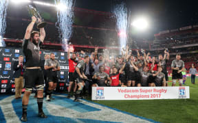 Crusader Sam Whitelock celebrates winning the 2017 Super Rugby trophy at Ellis Park Stadium.