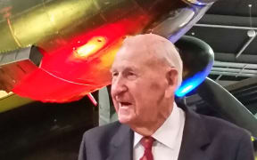 WWII veteran Les Munro in front of MOTAT's Lancaster Bomber before a ceremony to donate his medals and log books to the museum.