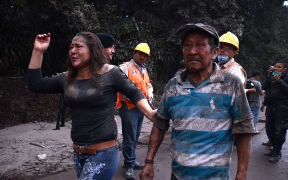 People flee El Rodeo village, Escuintla department, 35 km south of Guatemala City, after the eruption of the Fuego Volcano.