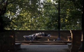 A person sleeps in Meridian Hill Park on 25 July, 2025 in Washington DC.