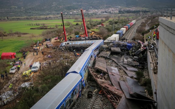 Police and emergency crews search the debris of a crushed wagon after a train accident in the Tempi Valley near Larissa, Greece on 1 March 2023. - At least 36 people were killed after a collision between two trains caused a derailment near the Greek city of Larissa late at night on February 28, 2023, authorities said.