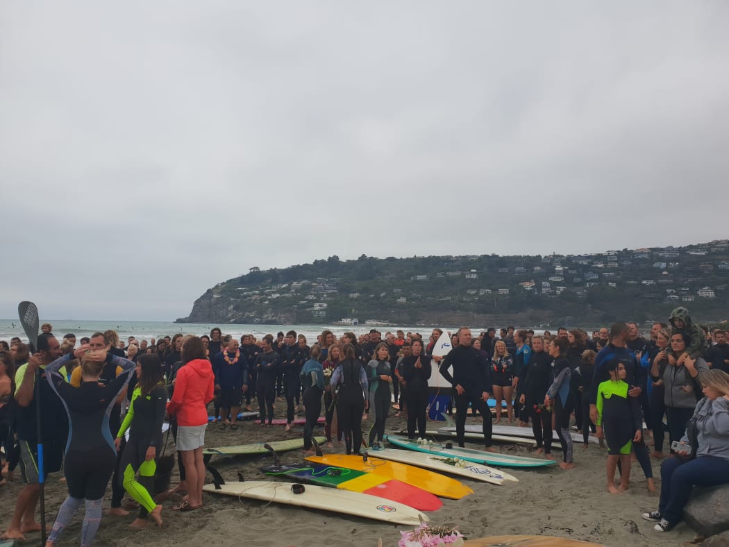 Hundreds of Christchurch surfers have paid tribute to the victims of last week's terror attacks with by paddling out at Sumner Beach.