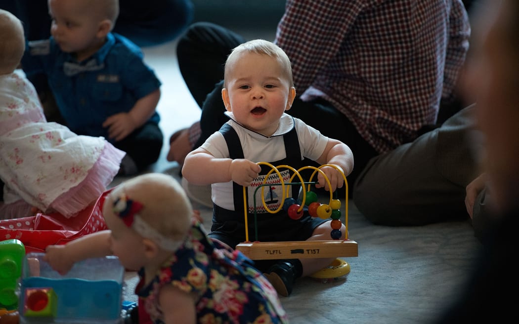 Prince George plays with toys during a Plunket nurse and parents group visit at Government House.